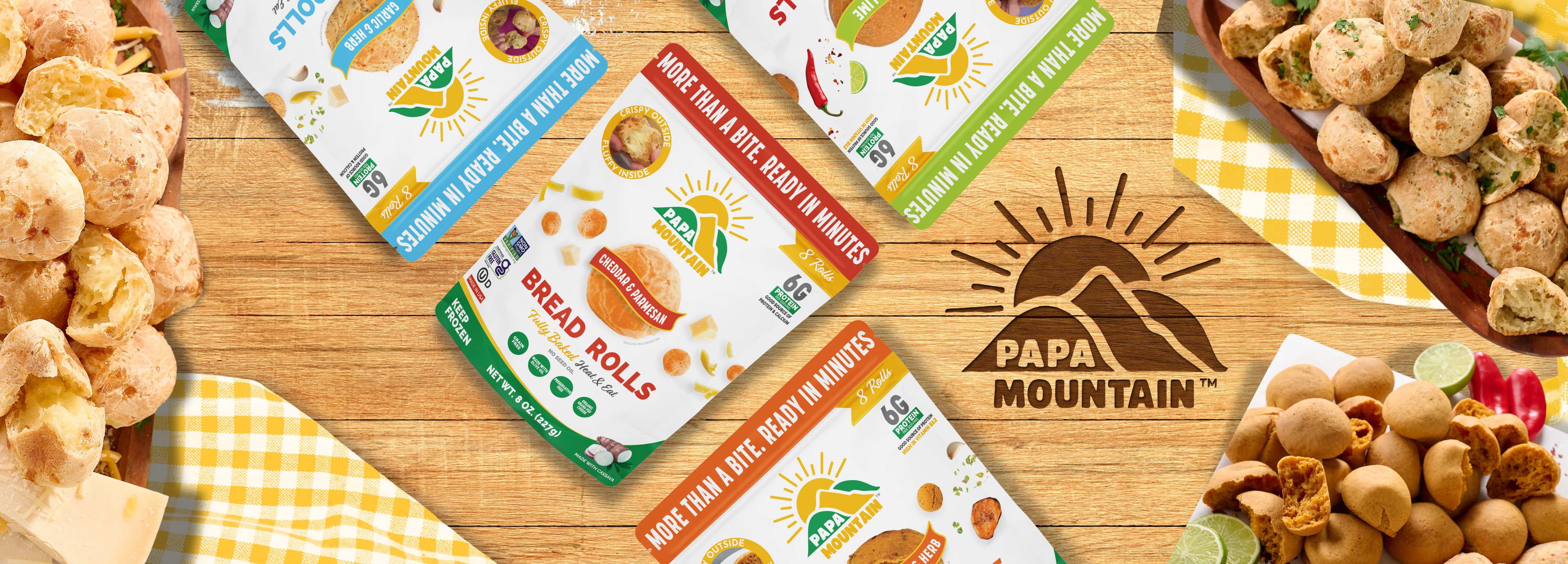 Papa Mountain food packaging on a wooden surface with snacks and a logo. Papa Mountain cheese bread rolls in assorted flavors on a wooden board with bowls of baked rolls — gluten-free, fully baked, ready in 7 minutes.