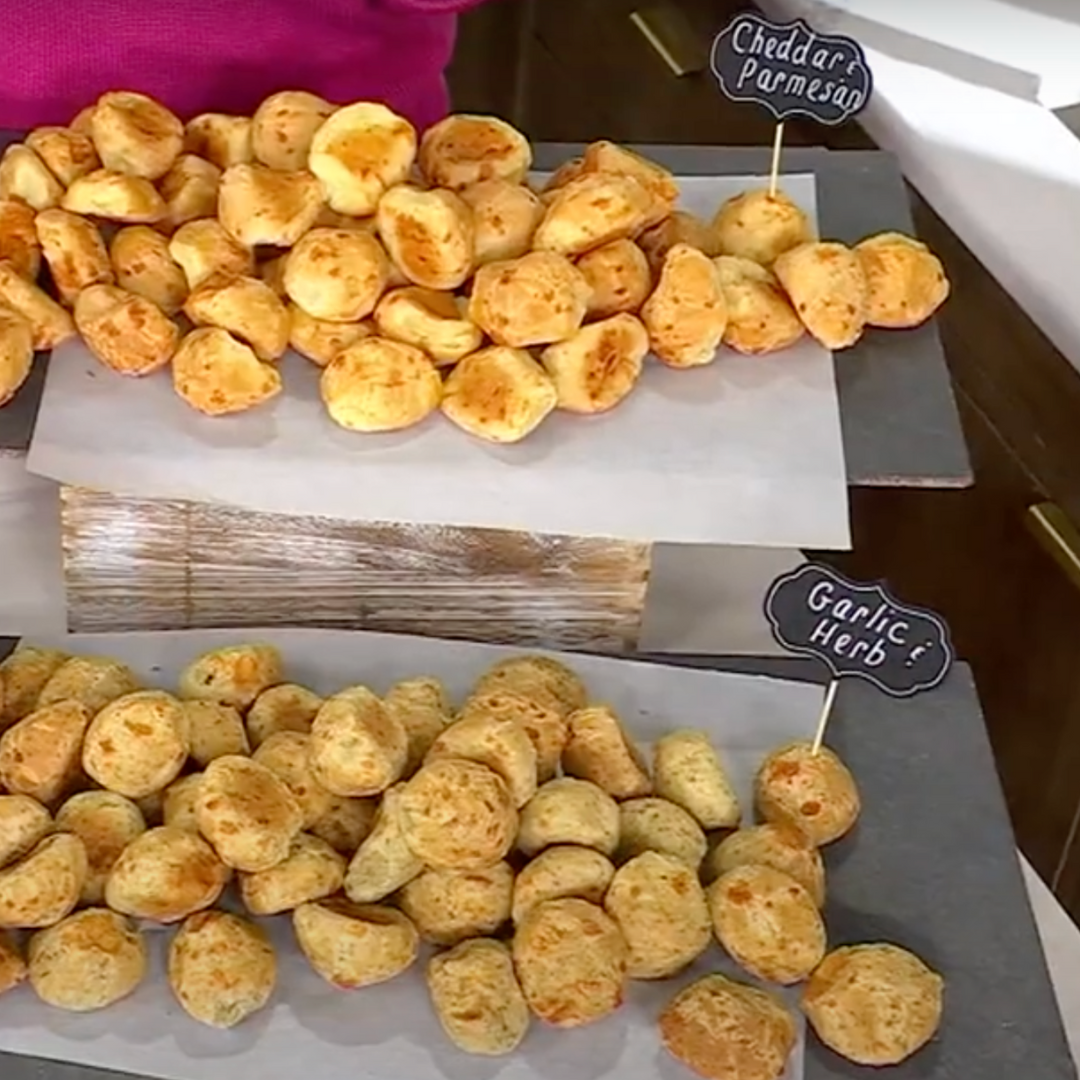 Flavor comparison display of Papa Mountain cheese bread rolls — gluten-free Cheddar & Parmesan on one table and Garlic & Herb on the other, clean label comfort food#PapaMountain
#FlavorShowdown
#CheddarVsGarlic
#CleanComfortFood
#GlutenFreeFavorites
#WholesomeSnackSpread
#GatheringReady
#BetterForYouEats
#SnackBoardInspo
#CheeseBreadLover
#ModernComfortFood
#FamilyFriendlyMeals