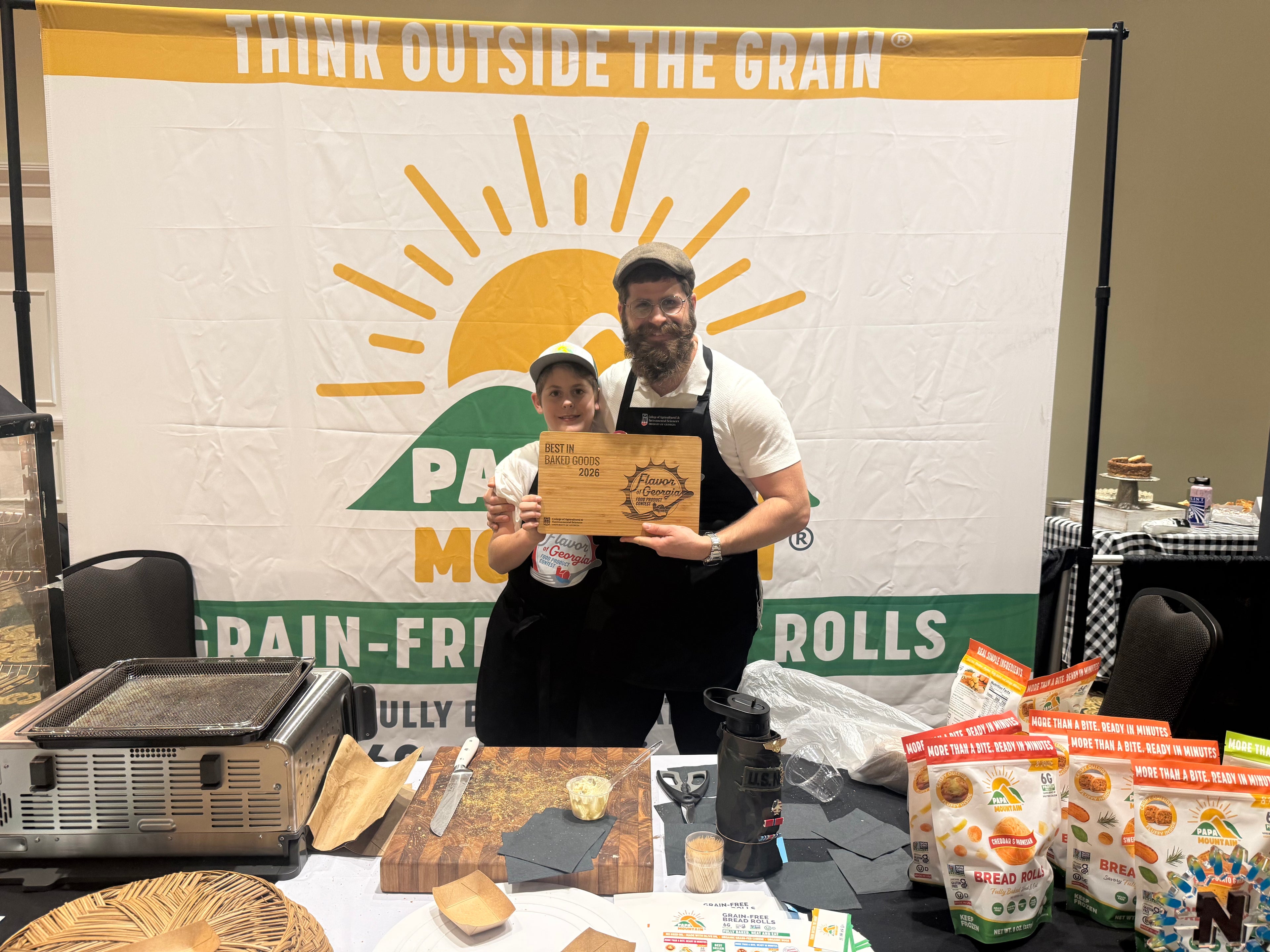 Solomon Cohen and his son holding the 2026 Flavor of Georgia Best in Baked Goods award for Papa Mountain's Garlic and Herb Bread Rolls Papa Mountain founder Solomon Cohen and his son celebrate the 2026 Flavor of Georgia Best in Baked Goods award, presented for the brand's Garlic and Herb Bread Rolls — one of 180 products entered across 12 categories