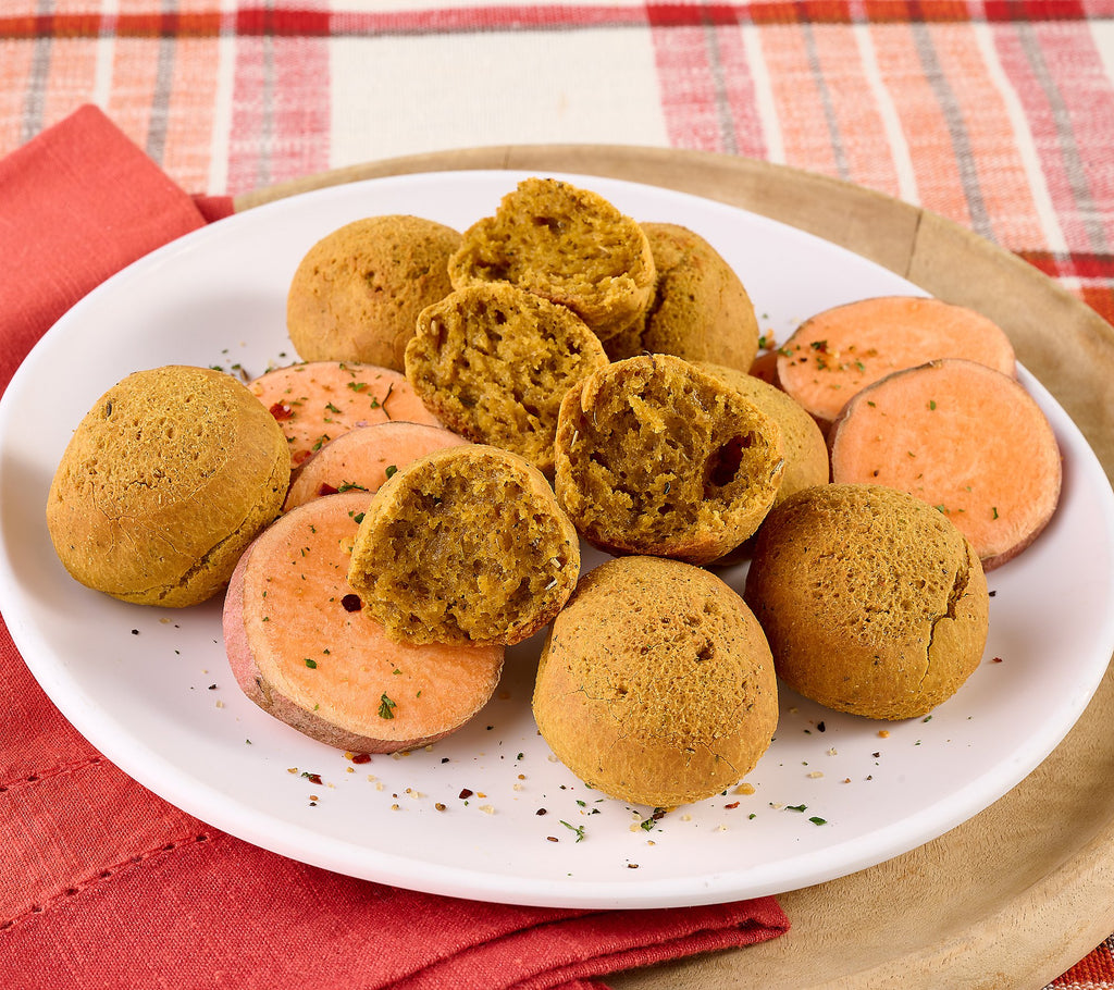 Plate of round and sliced sweet potatoes on a white plate with a red and white checkered tablecloth.papa mountain sweet potato and herb bread rolls made of cassava frozen heat and eat